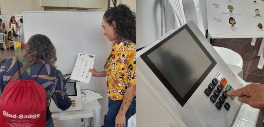 Foto mostra uma servidora colhendo as digitais de uma eleitora.